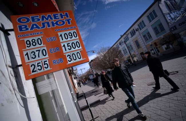 A man walks past a foreign currency exchange office in Simferopol on March 17.   AFP-Yonhap