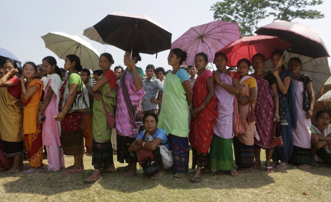 Karbi tribal women in traditional outfits stand in line to cast their votes outside a voting center in Diphu, in the Indian state of Assam, Saturday.   AP-Yonhap