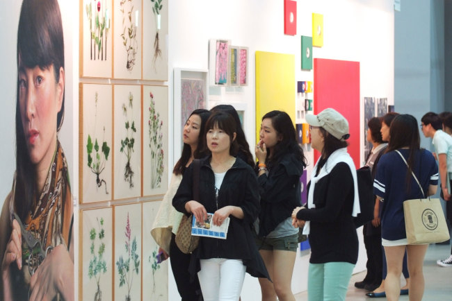 Visitors look at artworks at ArtShow Busan last year.   ArtShow Busan