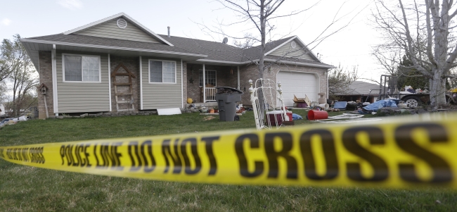 Police tape is shown in front of the scene where infant bodies were discovered and packaged in separate containers at a home in Pleasant Grove, Utah, Sunday.   AP-Yonhap