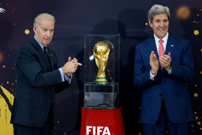 U.S. Vice President Joe Biden (left) and Secretary of State John Kerry applaud after unveiling the FIFA World Cup trophy during a ceremony at the State Department in Washington on Monday.   AP-Yonhap