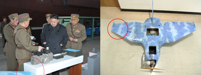 <YONHAP PHOTO-1319> 北, 김정은 부대 방문 때 무인기 추정 물체 등장 (서울=연합뉴스) 김정은 북한 국방위원회 제1위원장이 지난해 3월24일 1501부대를 방문했을 때 찍힌 사진에서 최근 파주와 삼척에서 발견된 북한의 것으로 추정되는 무인기 날개와 유사한 물체가 등장한 것으로 밝혀졌다. 국방부의 한 관계자는 15일 "파주와 삼척에서 추락한 무인기와 색깔과 형태가 유사하다"며 "특히 사진을 분석해보면 물체의 꺾인 각도가 파주 추락 무인기 날개와 일치한다"고 밝혔다. 북한 1501부대는 첨단군사장비 제작을 지휘하는 곳으로 알려졌다. 사진 왼쪽은 지난 3월 25일 조선중앙통신이 보도한 김정은의 1501부대 시찰 모습. 왼쪽 하단에 무인기 추정 물체 날개가 보인다. 사진 오른쪽은 파주 추락 무인기. 2014.4.15 << 연합뉴스 DB >> photo@yna.co.kr/2014-04-15 15:57:23/ <저작권자 ⓒ 1980-2014 ㈜연합뉴스. 무단 전재 재배포 금지.>
This March 24 photo shows North Korean leader Kim Jung-un looking at an object similar to the wing of a drone (right) found in Paju, Gyeonggi Province, on the same day.   Yonhap