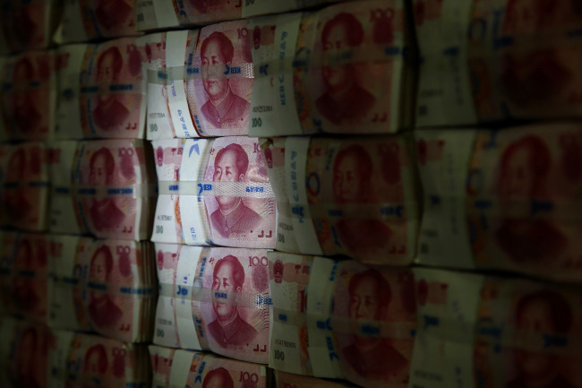 Chinese one-hundred yuan banknotes are stacked for a photograph at the Korea Exchange Bank headquarters in Seoul.   Bloomberg
