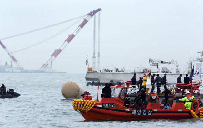 A Coast Guard boat floats near the sunken ferry on Friday.