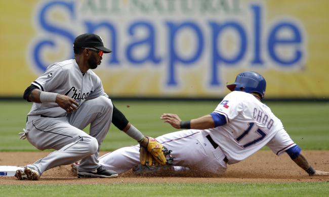 Texas Rangers outfielder Choo Shin-soo is tagged out by Chicago White Sox shortstop Alexei Ramirez in a steal attempt of second base in the first inning on Sunday. The Korean went 0 for 1 with a walk and an RBI.   AP-Yonhap