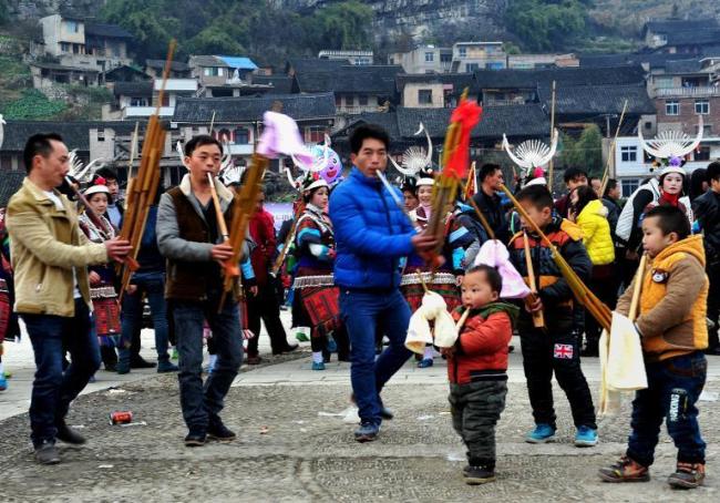 People celebrate the Reed Pipe Festival of the Miao ethnic group in Zhouxi township, Kaili, southwest China’s Guizhou province.   AFP
