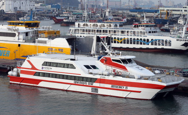 The 396-ton ferry Democracy No. 5 belonging to Chonghaejin Marine, the operator of the capsized Sewol, sits at the Incheon Port International Passenger Terminal on Monday after the company announced it would cease operation of four of its ferries across three routes.   Yonhap