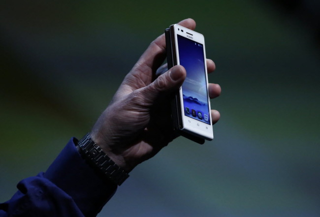 Andrew Connell, chief marketing officer of Huawei Technologies, displays an Ascend G6 smartphone at a news conference ahead of the Mobile World Congress in Barcelona in February.   Bloomberg