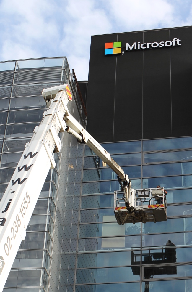 A worker on a lift truck finalizes the installation of the Microsoft logo on the former Nokia headquarters building in Espoo, Finland, Saturday.   Xinhua-Yonhap