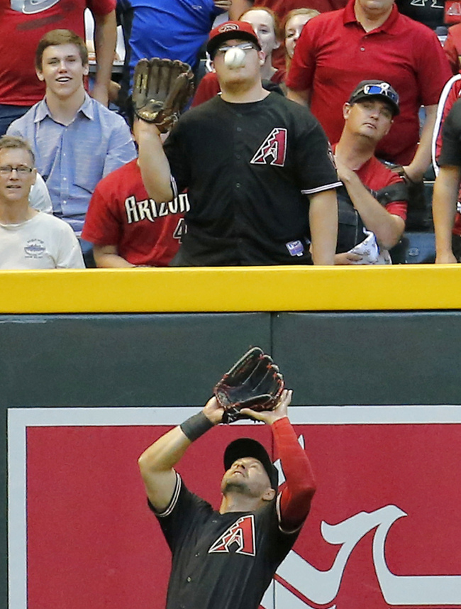 Arizona Diamondbacks’ Cody Ross and a fan wait for the ball hit by Philadelphia Phillies’ Marlon Byrd on Saturday.   (AP-Yonhap)