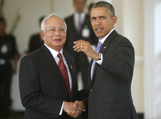 U.S. President Barack Obama (right) shakes hands with Malaysian Prime Minister Najib Razak at his residence in Kuala Lumpur on Sunday.   AP-Yonhap