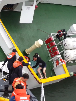 Sewol captain Lee Joon-seok, dressed in underwear, is seen being rescued by the Coast Guard off the coast of Jindo Island, South Jeolla Province, April 16.   Coast Guard