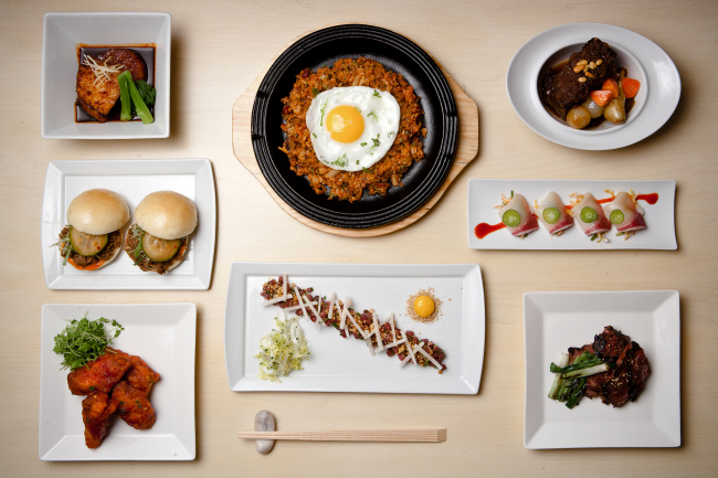 Danji’s poached sablefish with spicy daikon (from top left, clockwise); kimchi bacon fried “paella”; “Danji” braised short ribs with fingerlings and pearl onions; spicy yellowtail sashimi; skirt steak Korean barbecue style; steak tartare with quail yolk, toasted pine nuts, Asian pear; “K.F.C.” Korean fried chicken wings; bulgogi filet mignon sliders.   Melissa Hom