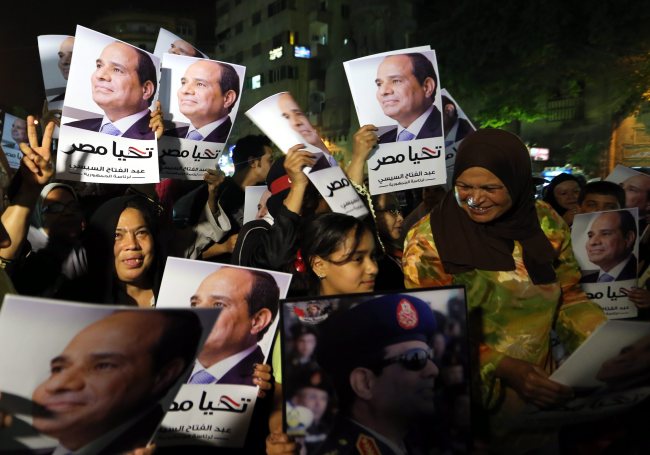 Supporters hold placards of Egypt’s former military chief Abdel-Fattah el-Sissi in Cairo on Monday.   EPA-Yonhap