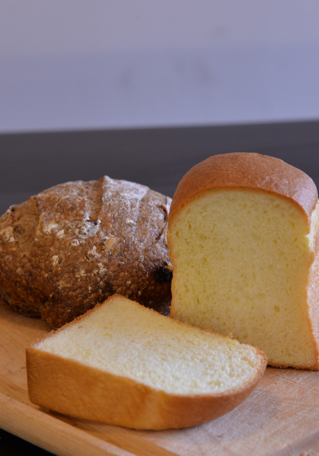 Mill's butter-hued brioche (front) and nutty cranberry-walnut pain de campagne (Lee Sang-sub/ The Korea Herald)