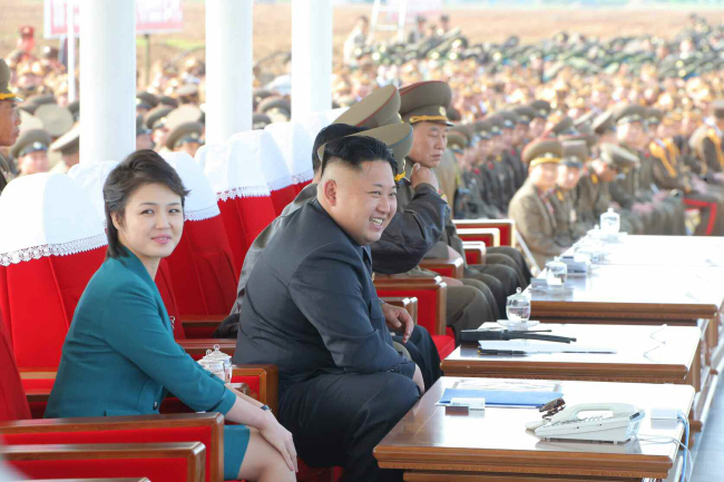 North Korean leader Kim Jong-un and his wife Ri Sol-ju attend a combat flight contest at an air force base. (Yonhap)