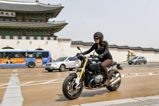 Elaine Ramirez test-rides on the BMW Motorrad R nineT in Gwanghwamun, central Seoul.   BMW Korea