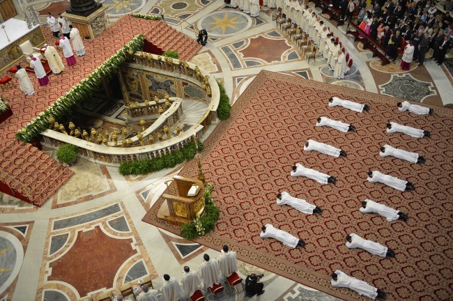 Thirteen new priests lay on the ground during a ceremony in which Pope Francis ordained them, in St. Peter’s Basilica at the Vatican on Sunday.   AP-Yonhap