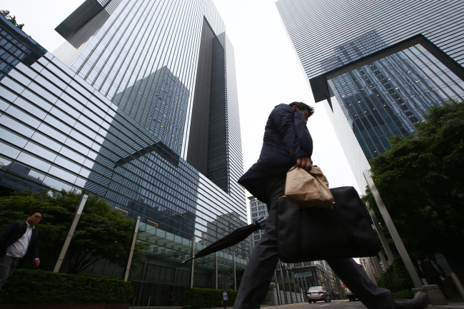 A commuter walks past the Samsung Electronics Co. Seocho office building in Seoul.   Yonhap