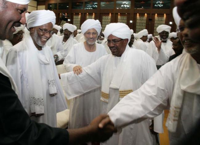 Sudan’s President Omar al-Bashir (center) greets supporters in Khartoum. (AFP)