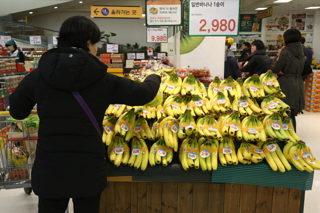 A customer shops for Dole bananas at an E-Mart store in Incheon.   Bloomberg