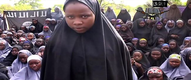 A screengrab from a video of Boko Haram obtained by AFP shows a girl, wearing the full-length hijab talking to the camera at an undisclosed rural location.   AFP-Yonhap