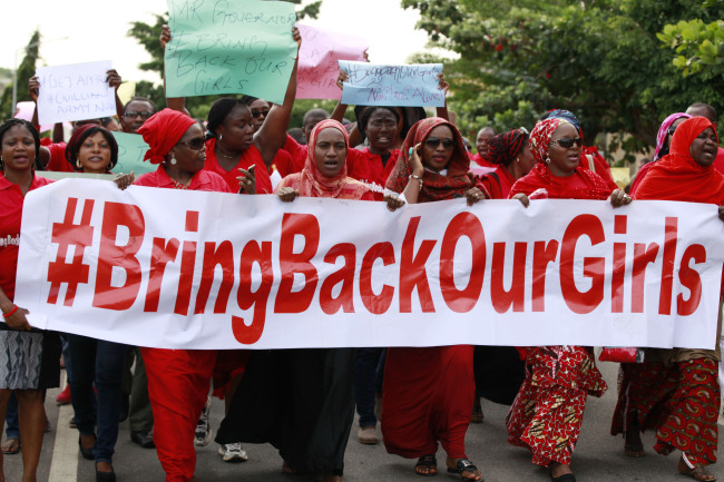 Women attend a demonstration calling on the government to rescue the kidnapped schoolgirls of the Chibok secondary school in Abuja on Tuesday.   AP-Yonhap
