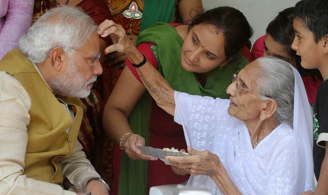 Main opposition Bharatiya Janata Party prime ministerial candidate Narendra Modi (left) is blessed by his mother Hira Ba in Ahmedabad, India, Friday.   AFP-Yonhap