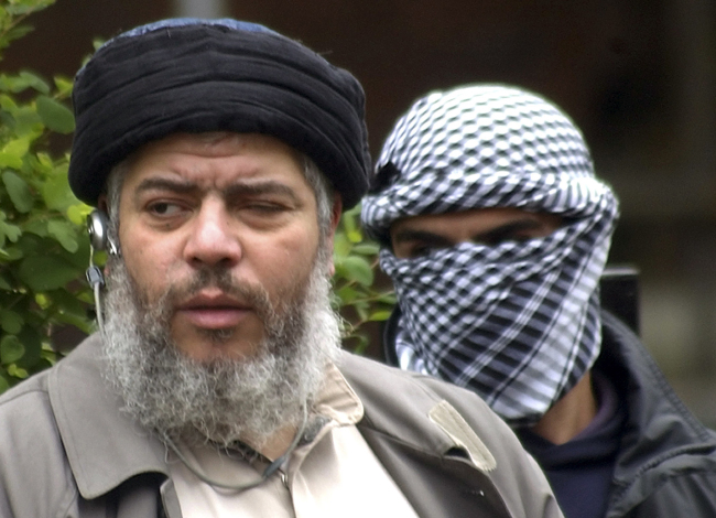 Muslim cleric Mustafa Kamel Mustafa arrives to conduct Friday prayers in the street outside the closed Finsbury Park Mosque in London in 2004.   AP-Yonhap