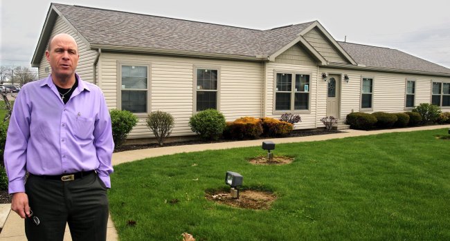 Dave Ball, sales manager with Hartzler’s Quality Housing, stands outside a Skyline modular home in New Philadelphia.   Akron Beacon Journal/MCT
