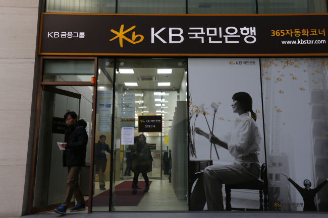 A man exits the Kookmin Bank branch at KB Financial Group’s headquarters in Seoul.   Bloomberg