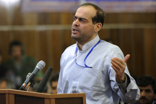 Mahafarid Amir Khosravi speaks at his trial in a court in Tehran in February 2012.   AP-Yonhap