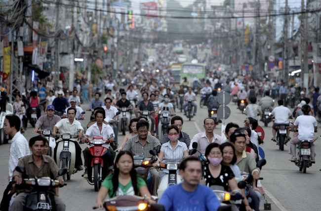 Motorcyclists ride along a busy street in Ho Chi Minh City, Vietnam.   Bloomberg