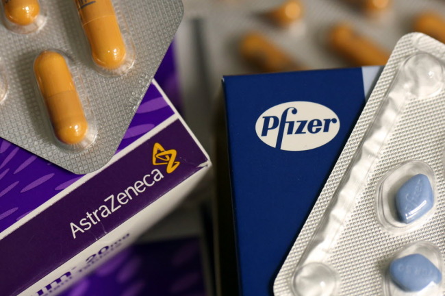 Logos of Pfizer and AstraZeneca are seen on boxes of pharmaceutical products in London.   Bloomberg