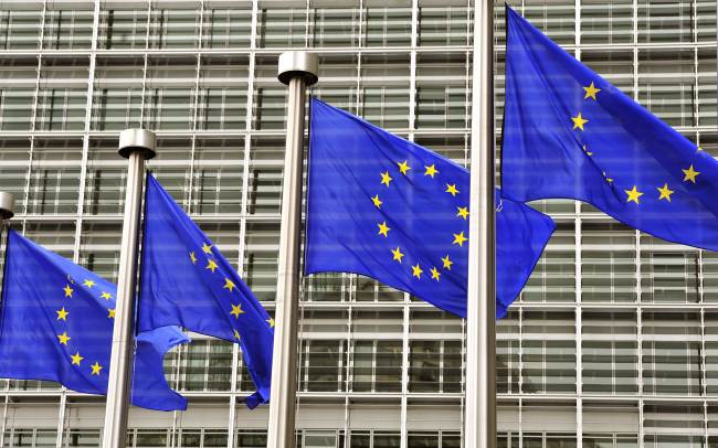 European Union flags fly at the entrance of the EU Commission Berlaymont building in Brussels.   AFP-Yonhap