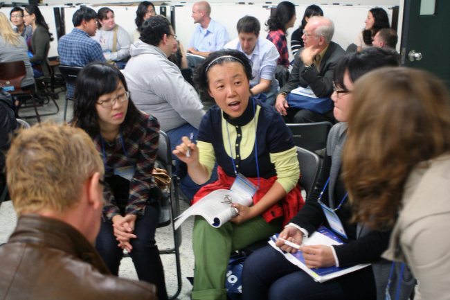 Participants discuss English teaching techniques at a previous KOTESOL conference.   KOTESOL
