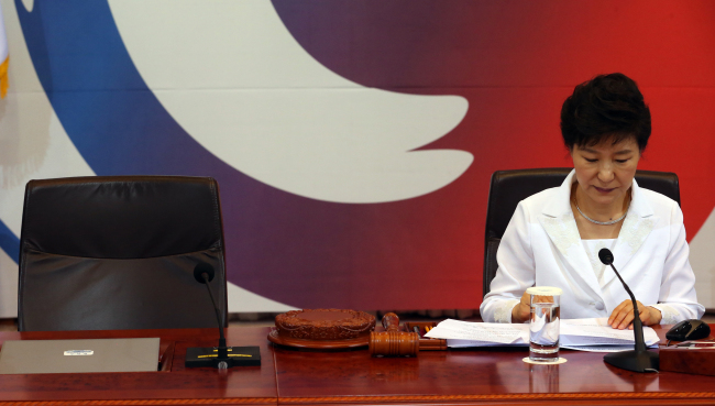 President Park Geun-hye looks at documents after speaking at Tuesday’s Cabinet meeting at Cheong Wa Dae.   Yonhap