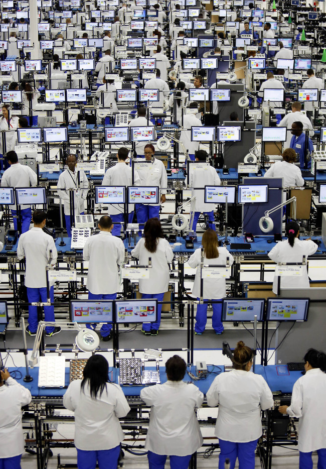 Employees assemble Motorola Solutions Inc. Moto X smartphones at the Flextronics International Ltd. factory in Fort Worth, Texas.   Bloomberg