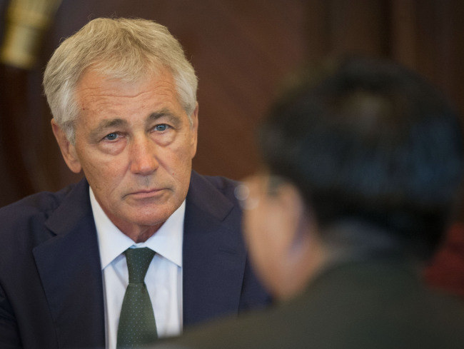U.S. Defense Secretary Chuck Hagel listens to Lt. Gen. Wang Guanzhong, China’s deputy chief of the general staff, at the start of their meeting in Singapore on Saturday.   AP-Yonhap
