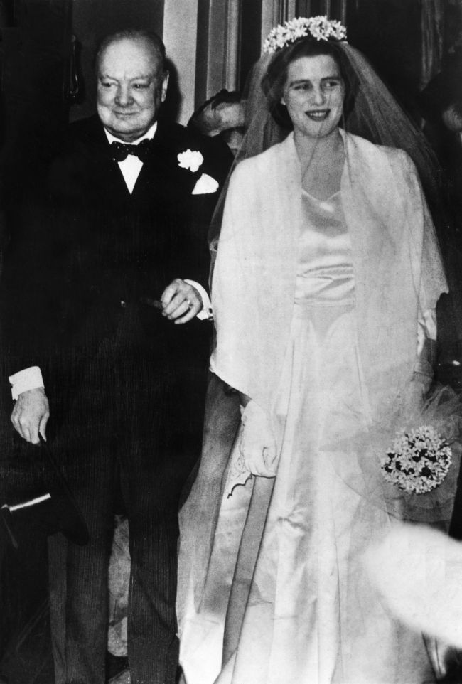 Former British Prime Minister Winston Churchill (left) walks his daughter Mary Churchill to the altar of Westminster Abbey in London as she marries Christopher Soames on Feb. 12, 1947.   AFP-Yonhap