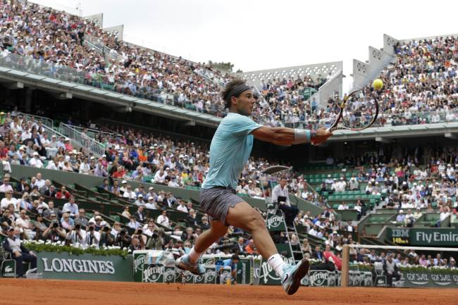 <YONHAP PHOTO-1692> Spain's Rafael Nadal returns the ball to Serbia's Dusan Lajovic during their French tennis Open round of sixteen match at the Roland Garros stadium in Paris on June 2, 2014. AFP PHOTO / KENZO TRIBOUILLARD../2014-06-02 22:30:51/ <저작권자 ⓒ 1980-2014 ㈜연합뉴스. 무단 전재 재배포 금지.>
Spain’s Rafael Nadal returns a shot at the French Open on Monday.   AFP-Yonhap