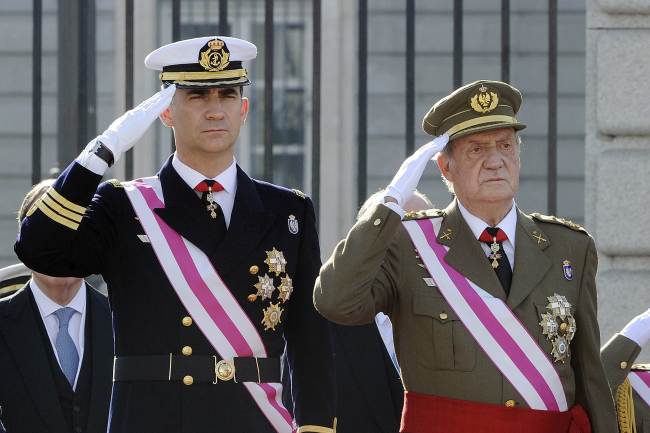 Spain’s Prince Felipe and King Juan Carlos salute during a ceremony in Madrid in January 2012.   AFP-Yonhap