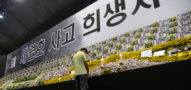 A mourner prays for the victims of sunken ferry Sewol at a memorial hall in Ansan, Gyeonggi Province, Tuesday, which marked the 49th day since the accident. Buddhists believe that the soul of the deceased leaves the physical world seven weeks after death.   Park Hyun-koo/The Korea Herald