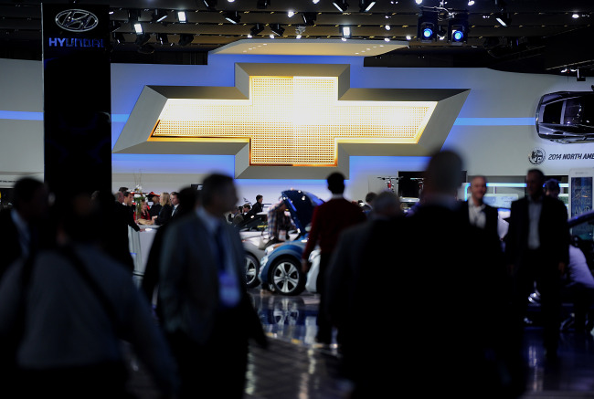 Attendees visit the General Motors Co. Chevrolet booth during the 2014 North American International Auto Show in Detroit on Jan. 14     Bloomberg