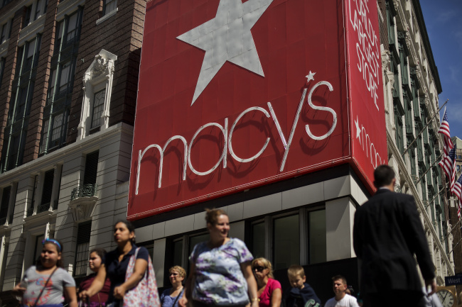 Shoppers walk past a Macy’s Inc. store in New York.   Bloomberg