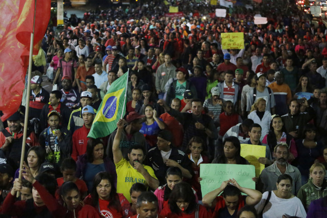 Members of the Homeless Workers Movement march during a protest demanding better public services and against the money spent on the World Cup preparations in Sao Paulo, Brazil, Wednesday.   AP-Yonhap