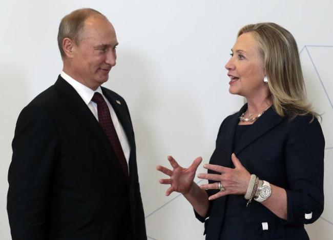 Russian President Vladimir Putin (left) listens to former U.S. Secretary of State Hillary Clinton during the Asia-Pacific Economic Cooperation Summit in Vladivostok, Russia, Sept. 8, 2012.   AFP