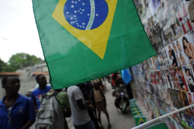 A Brazilian flag hangs near a street stall in Port au Prince.   AFP