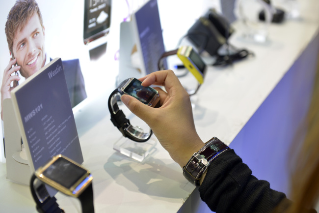 An attendee looks at a Westin Technology Co. smart watch during the Computex Taipei 2014 expo at the Taipei Nangang Exhibition Center in Taipei on June 4.   Bloomberg
