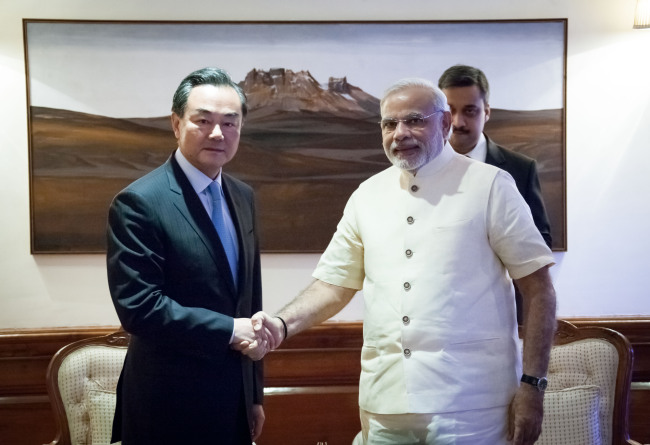 Indian Prime Minister Narendra Modi (right) meets with Chinese Foreign Minister Wang Yi in New Delhi on Monday.   Xinhua-Yonhap